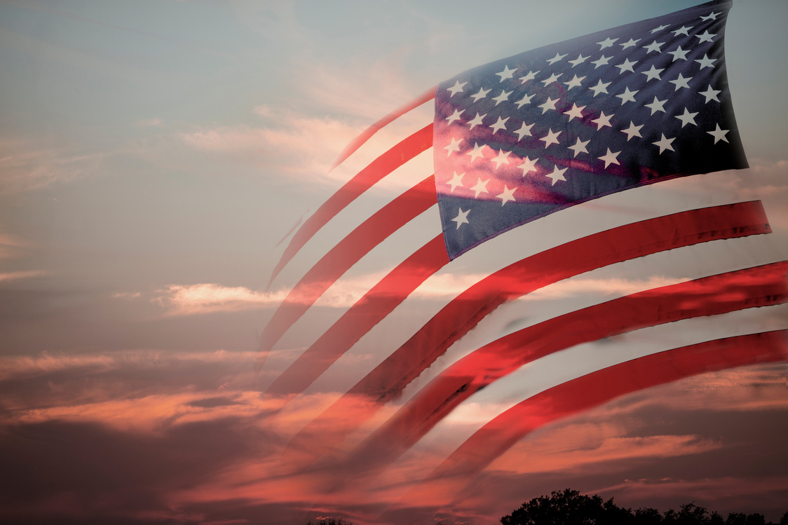 Background:  American flag with sunset background. USA. Patriotism.
